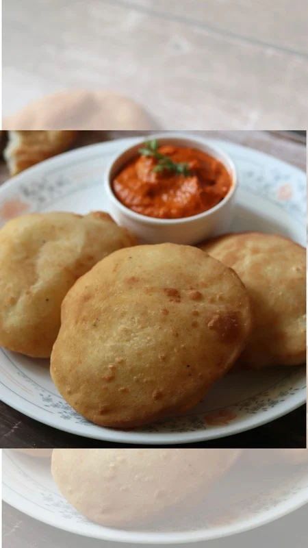 Golden puffed poori served with dipping sauce
