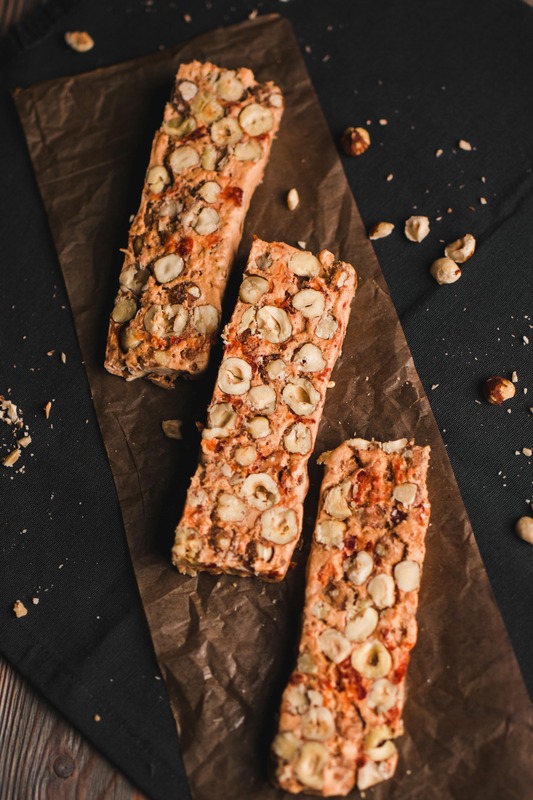Nutty millet bars arranged on dark parchment